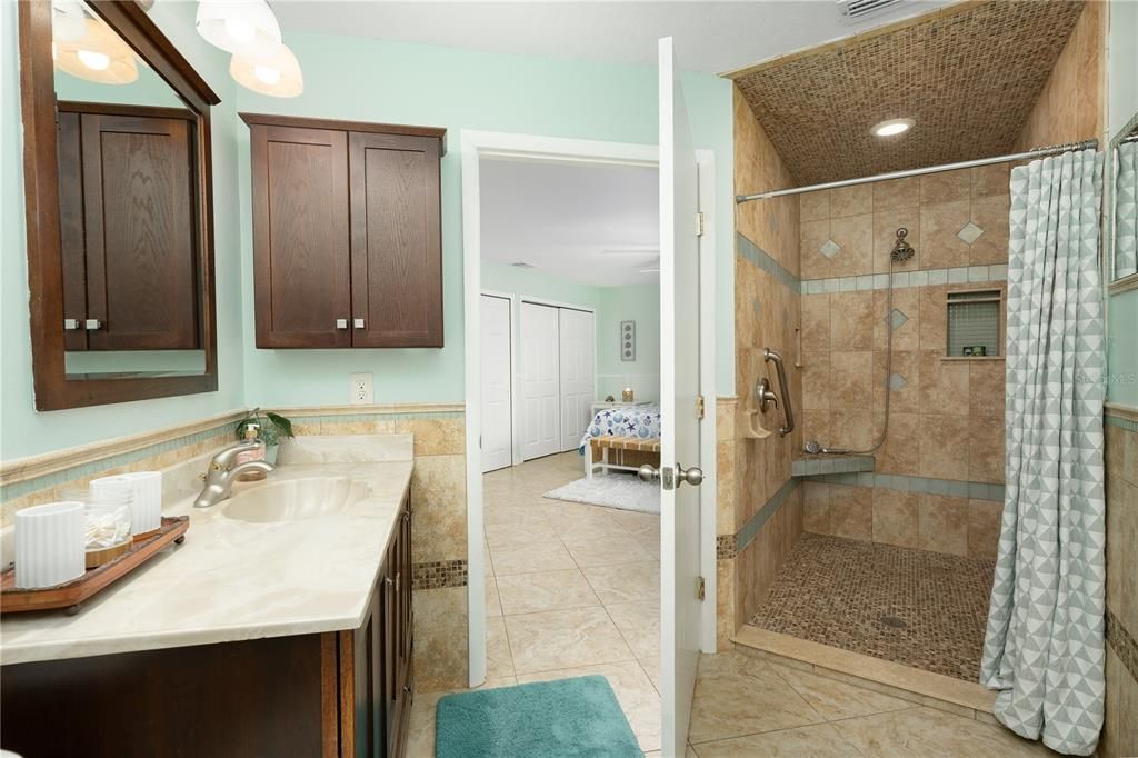 Bathroom with tile flooring, vanity, and a shower with shower curtain