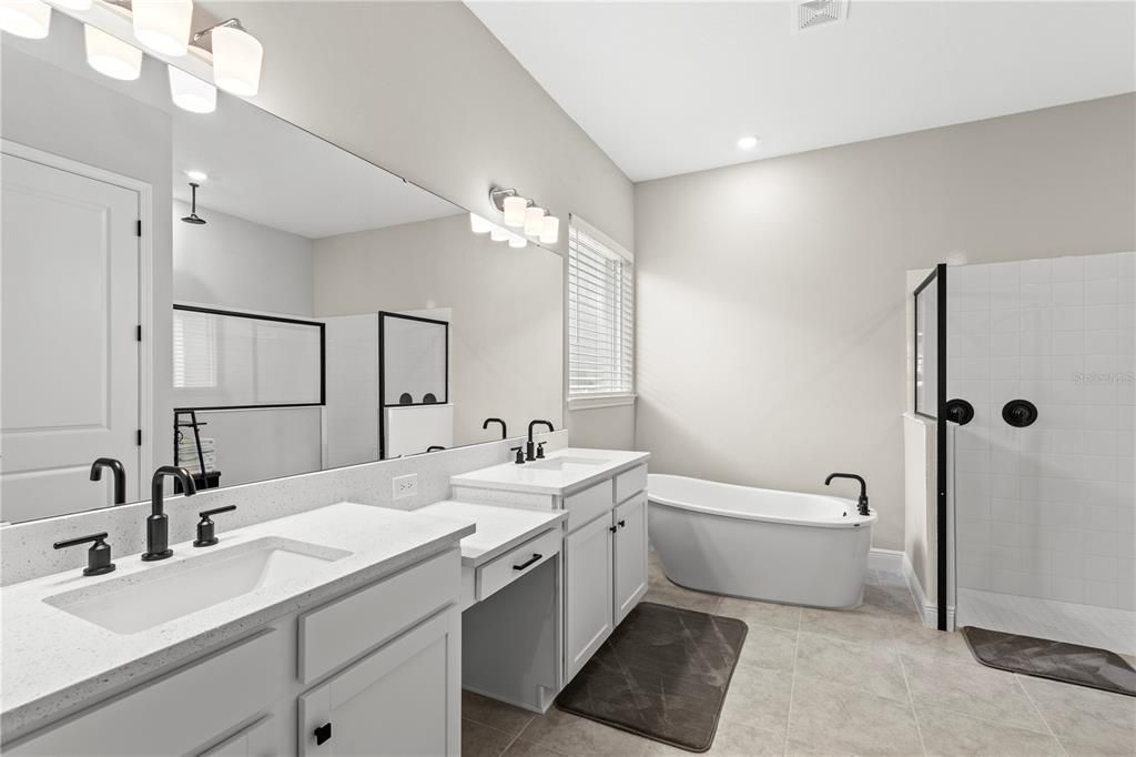 Primary Bathroom with Double Sink Quartz Counter Vanity, Soaking Tub and Walk-in Shower