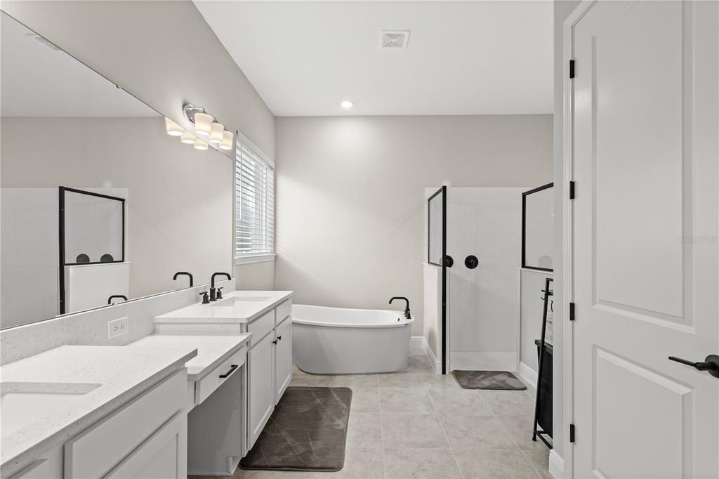 Primary Bathroom with Double Sink Quartz Counter Vanity, Soaking Tub and Walk-in Shower
