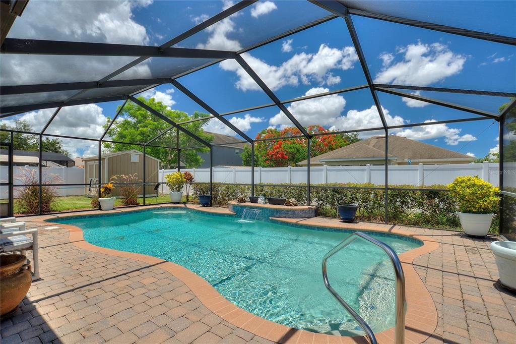 Pool with corner whirlpool jets and a peaceful waterfall