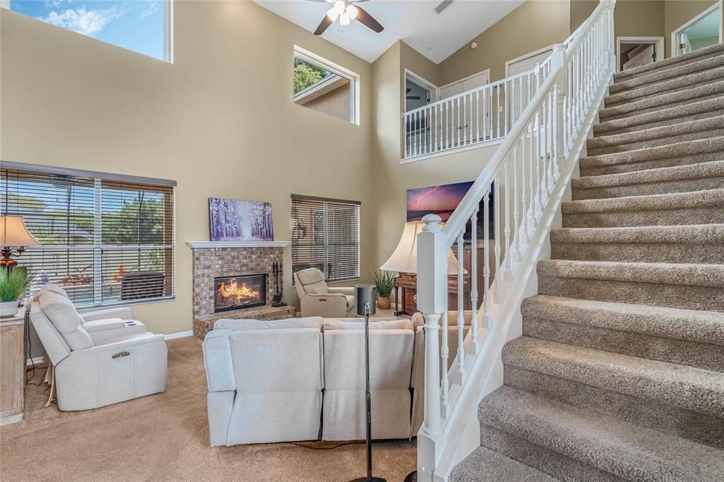 So much Natural light! Beautiful Wooden Stair Rail. Recessed lighting and Ceiling fan.