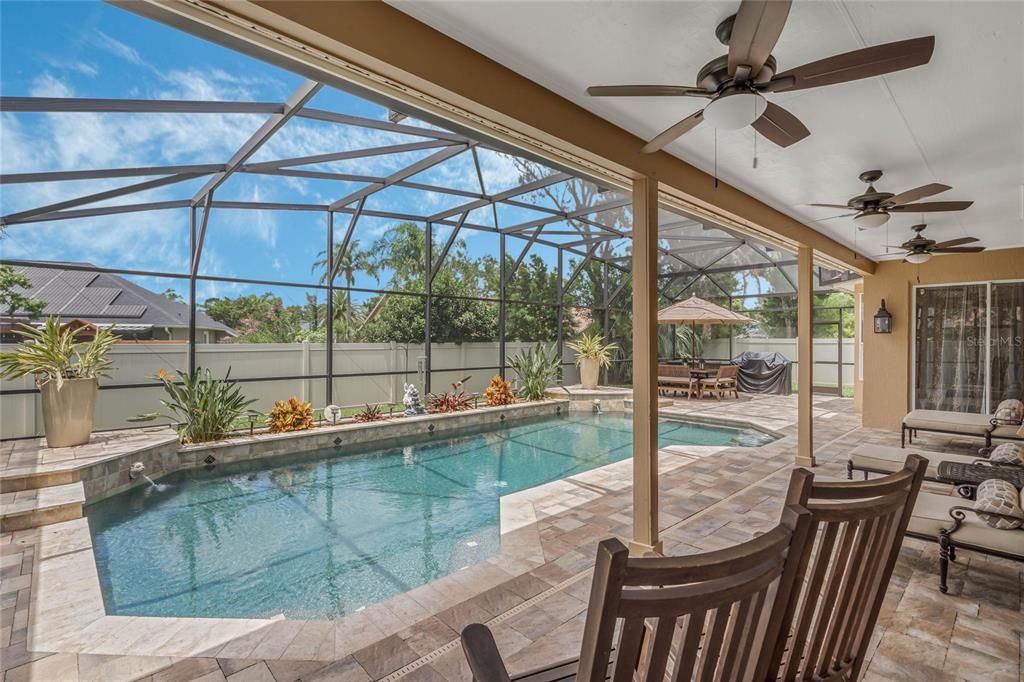 Beautifuly view of the Covered Patio and New Pool Pavers and tile. Upgraded Vinyl Fence