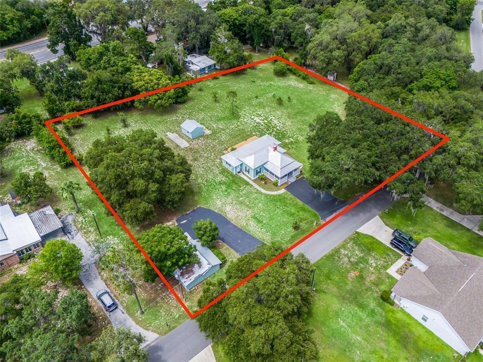 Aerial shot showing the extent of this 1.6 acre property and the two outbuildings