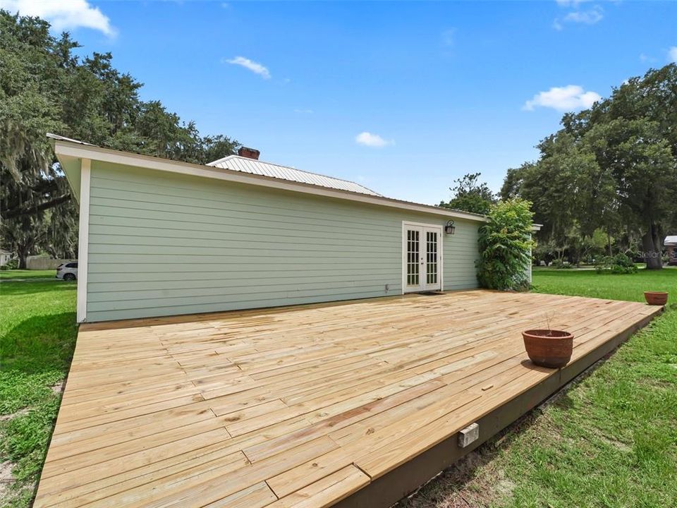 View showing expanse of rear deck and access French doors