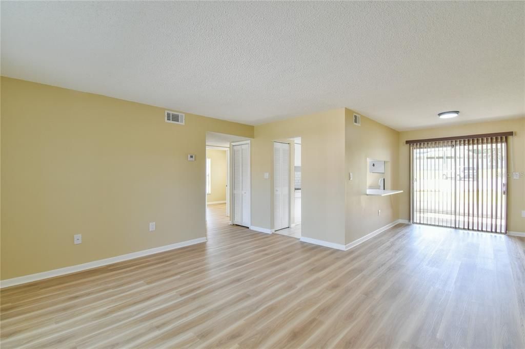 Entering into the Living area, Dining area and sliding glass door to screened patio