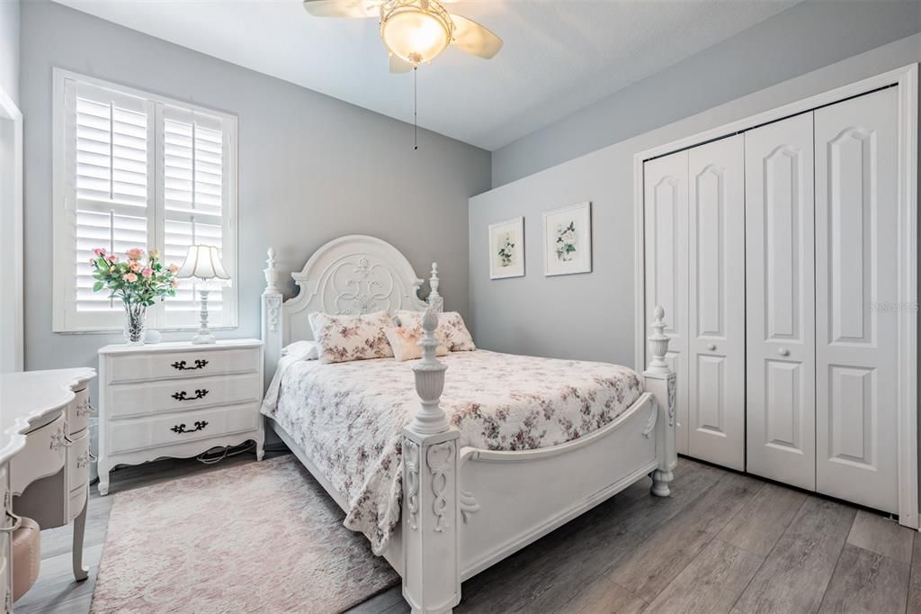 Guest room, Laminate Flooring and ceiling fan with light fixture.