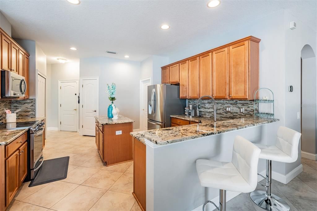 Stainless Steel Appliances, Granite Countertops, 2 pantries, Tile Flooring on the diagonal and open to the family room.