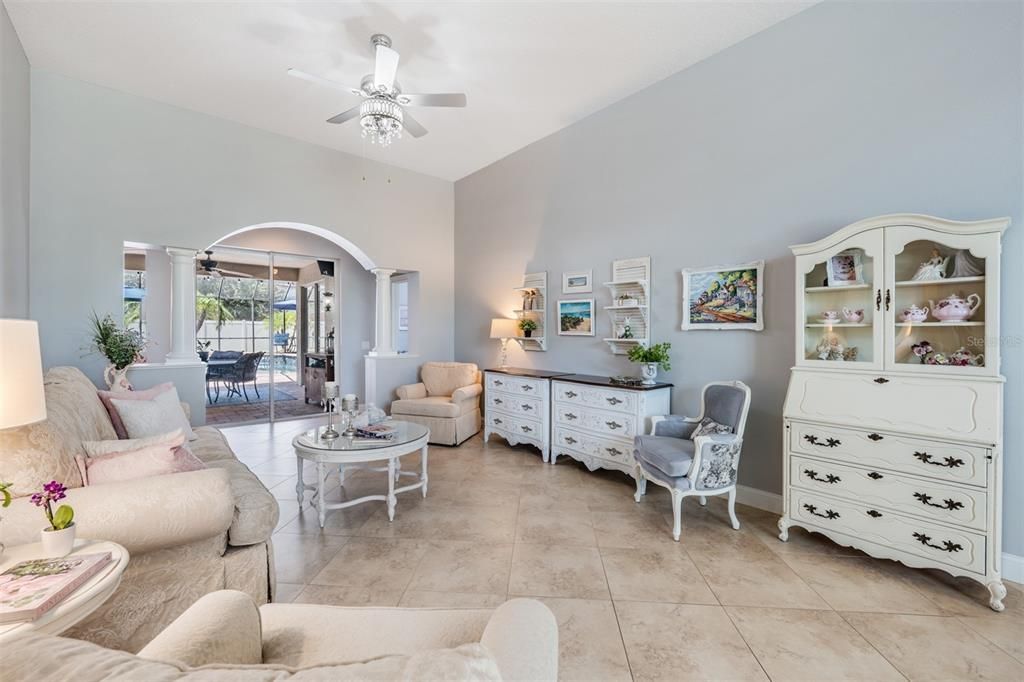 Large Living Room area with new light fixture and tile on the diagonal.