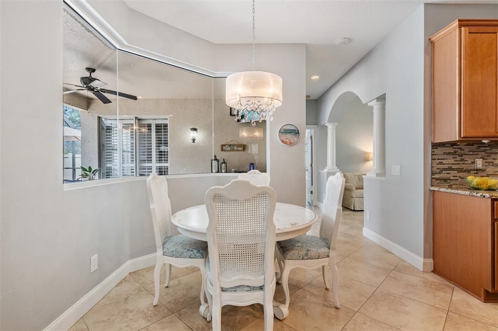 Dinette area - open to the kitchen and family room with views of the pool.