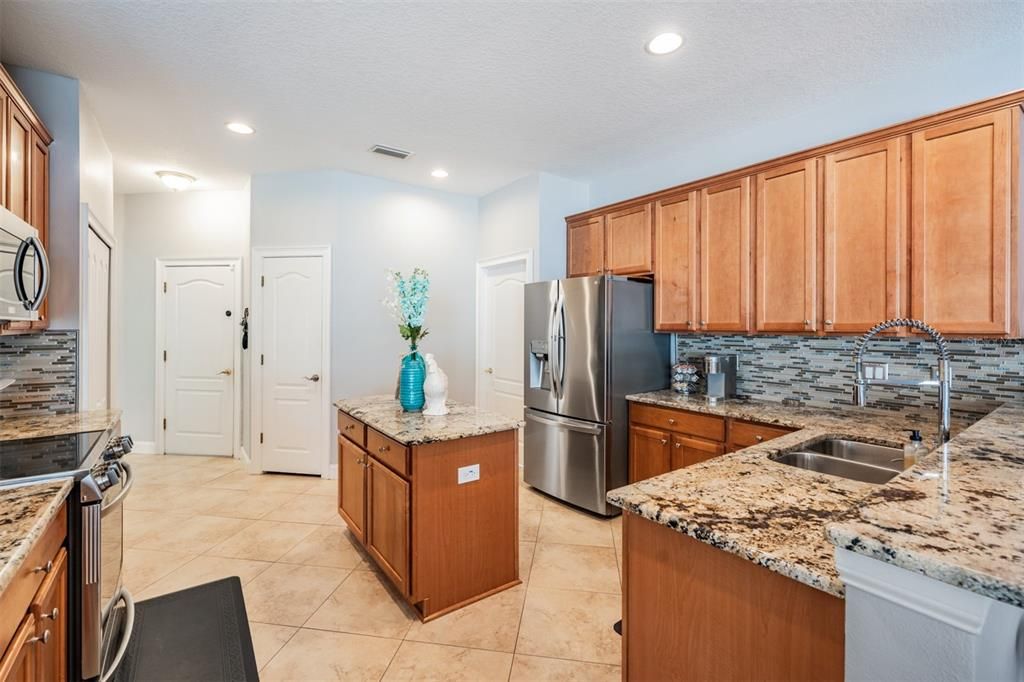 Stainless Steel Appliances, Granite Countertops, 2 pantries, Tile Flooring on the diagonal and open to the family room.