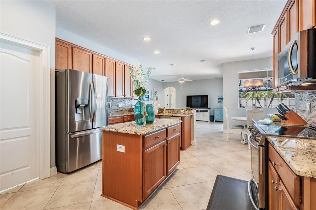 Stainless Steel Appliances, Granite Countertops, 2 pantries, Tile Flooring on the diagonal and open to the family room.