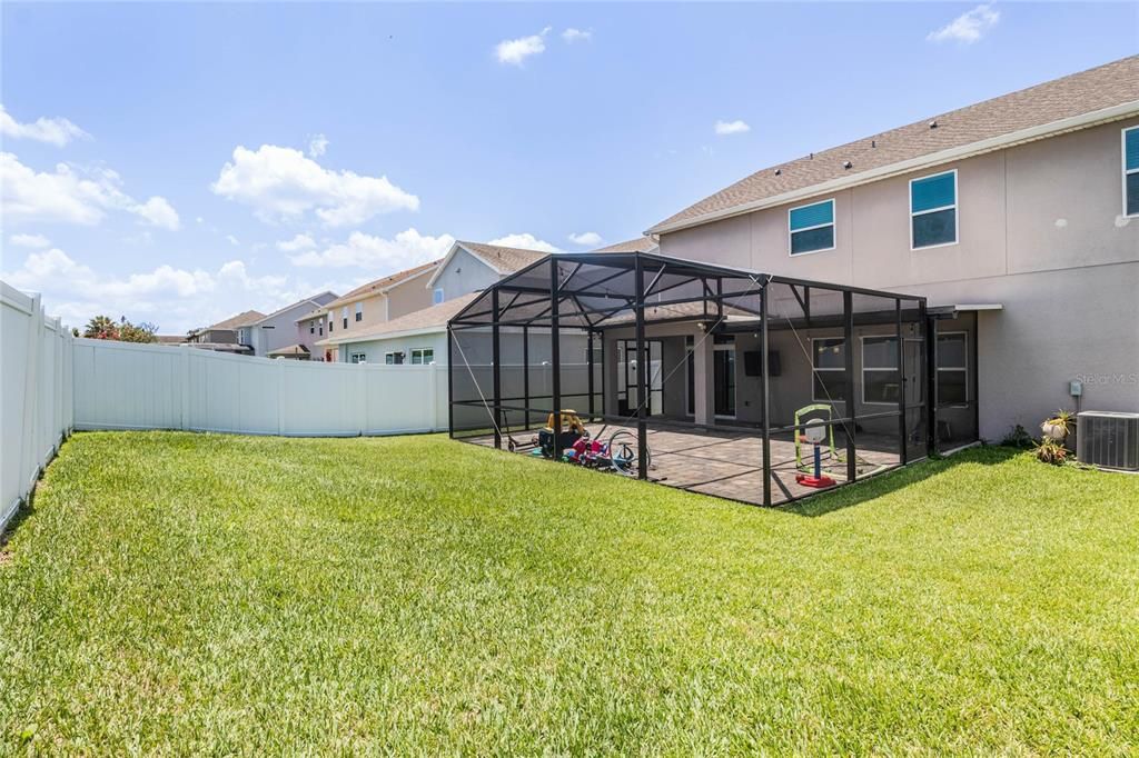 Fully fenced in yard, grassy area and screened patio.