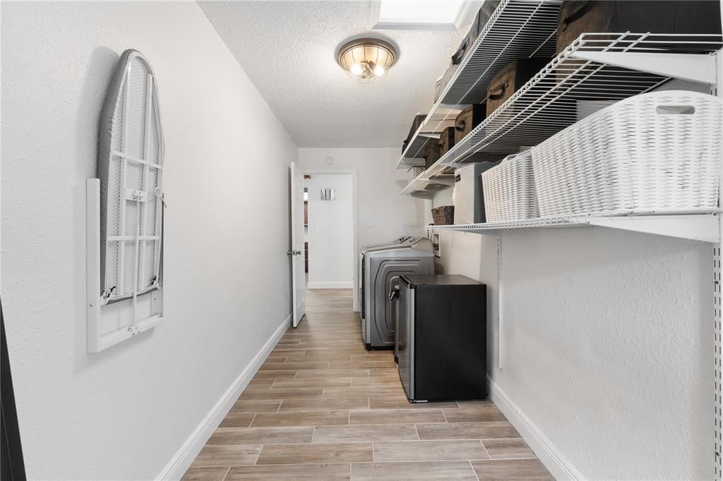 Plenty of room in the laundry room for an additional refrigerator & storage!