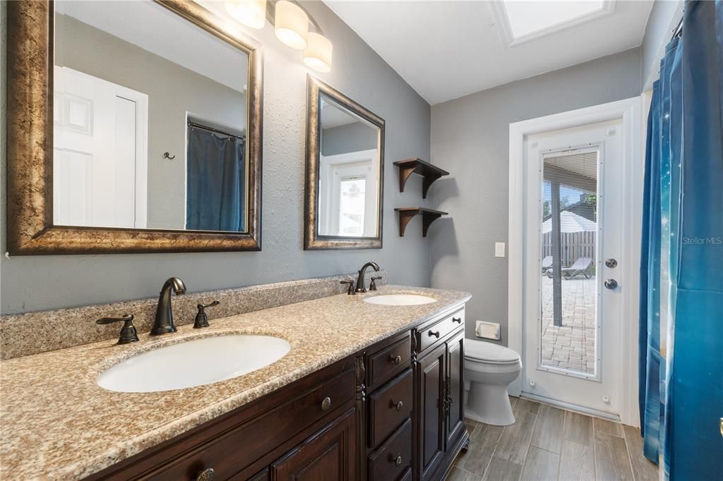 Guest bath with dual vanities & pool access!