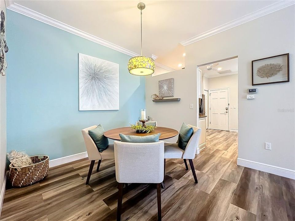 Dining room with a view into the kitchen.