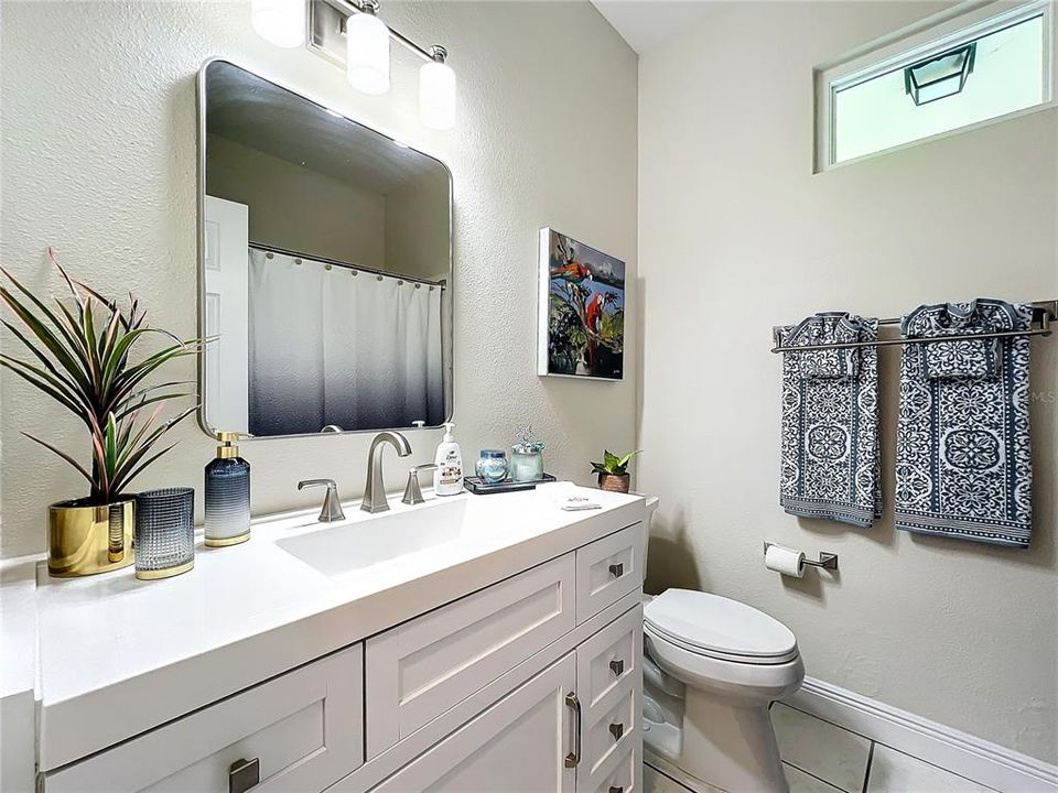 Guest ensuite bathroom with higher toilet and clerestory window for additional lighting .