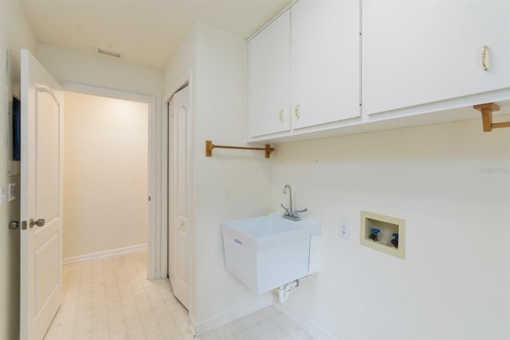 Downstairs Inside laundry room with door going out to side yard near garage