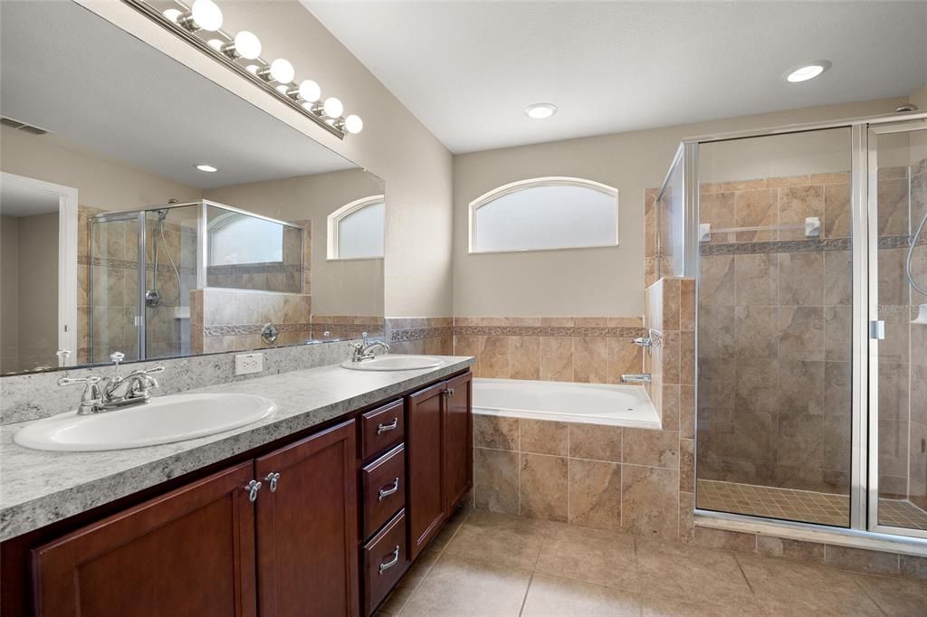 Double Sinks, tub and shower in the primary bathroom.