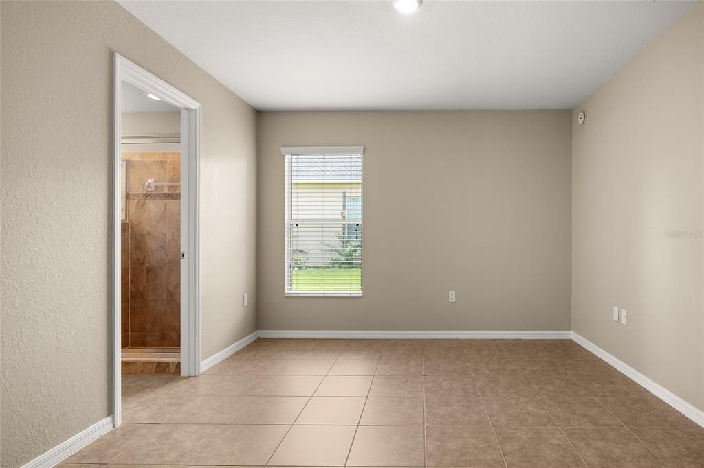 Primary bedroom offers ample wall space for versatile furniture arrangement.