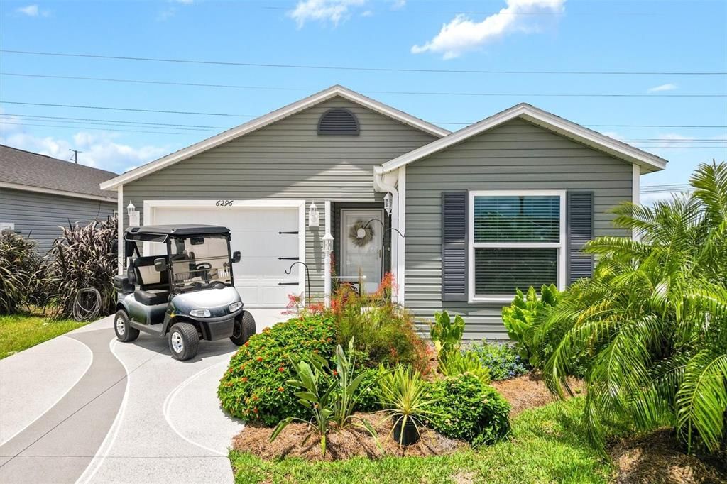 FRONT OF HOME GARAGE, GOLF CART GARAGE & INCLUDED GOLFCART