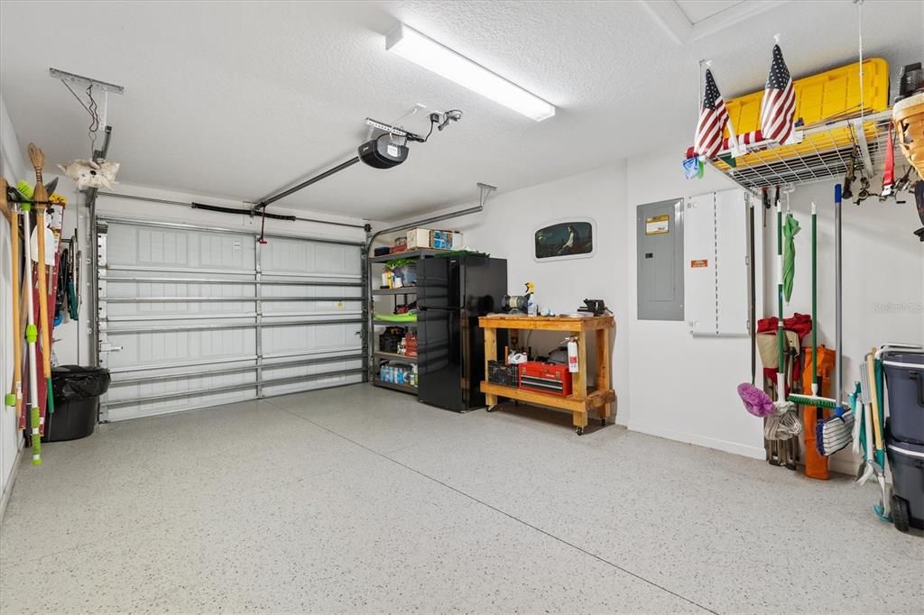 GOLF CART GARAGE WITH UTILITY SINK & NOVA WATER FILTRATION SYSTEM.  LAWN EQUIPMENT ON THE RIGHT STAYS - ALL ON LEFT IS NOT INCLUDED