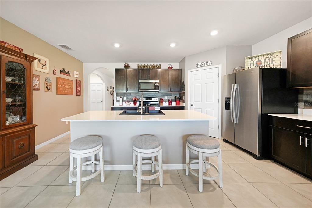Kitchen with Wood Cabinets - Stainless Appliances - Solid Surface Countertops