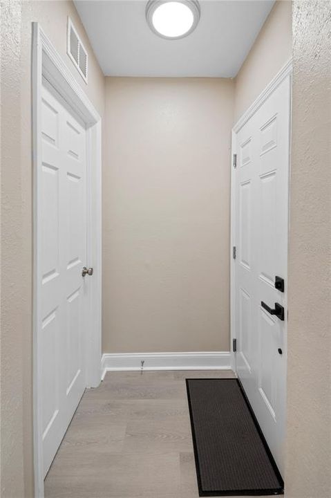 Front entry door (on right) and entry to Bedroom 3 (on left).