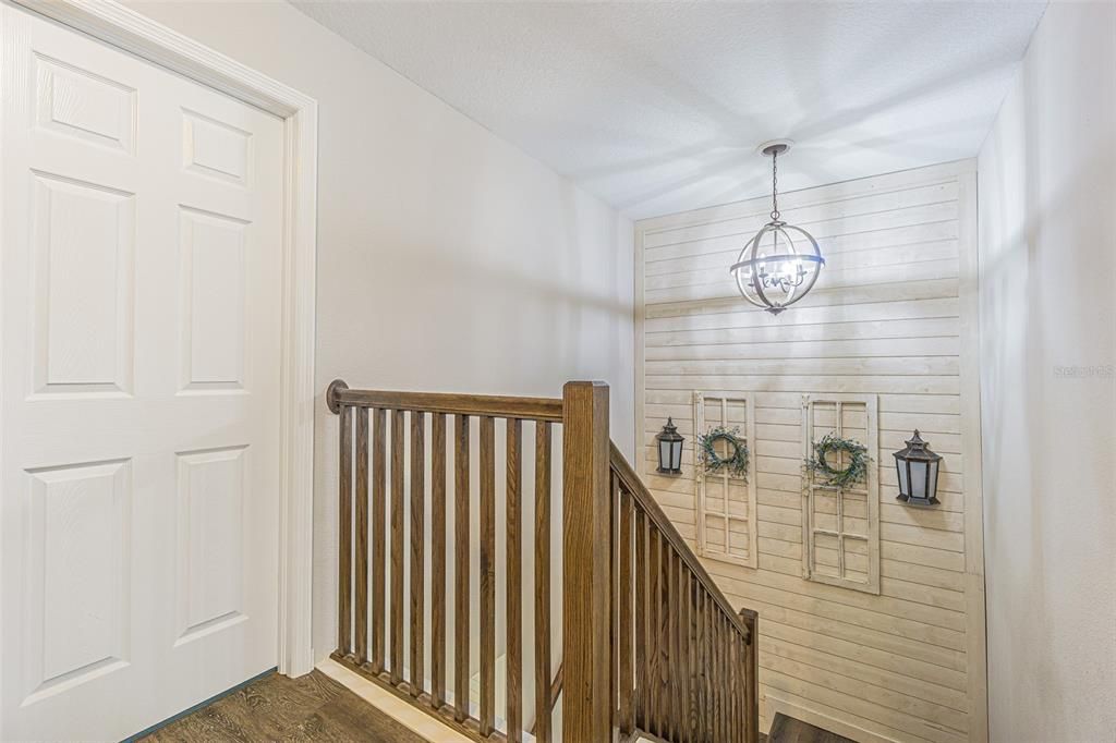 Custom accent wall with lighting at stair landing