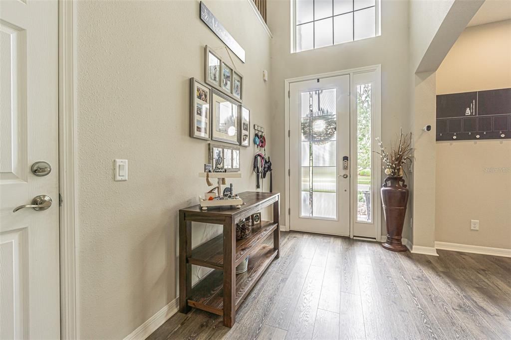 Spacious entry with upgraded leaded glass door and full ceiling height to second floor