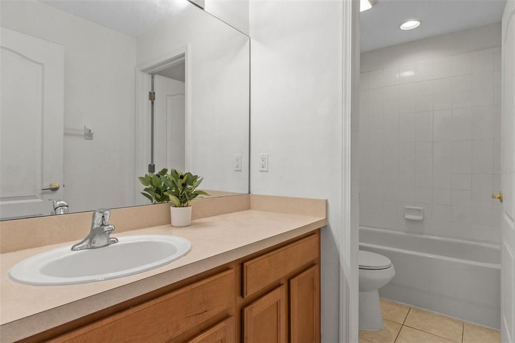 This guest  bathroom features a tub/shower combo