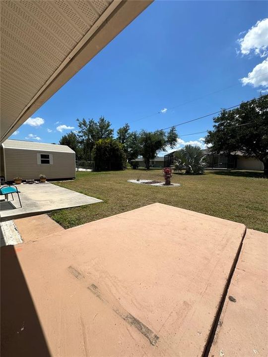 Large patio with a partially fenced in massive backyard