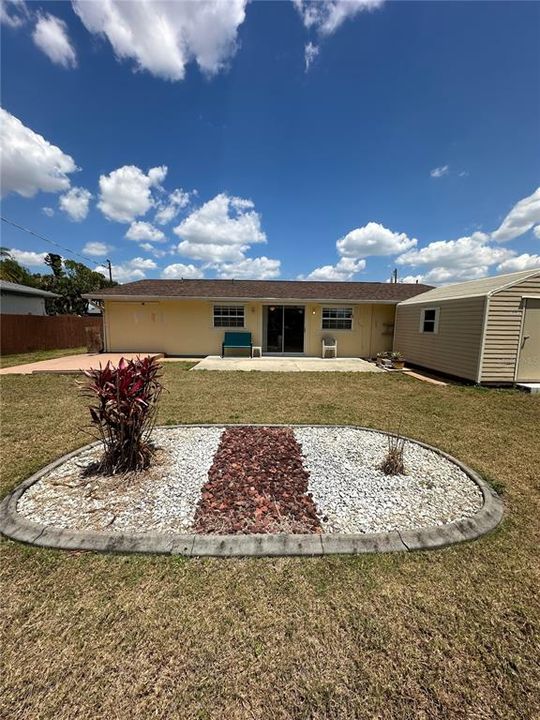 Large patio with a partially fenced in massive backyard