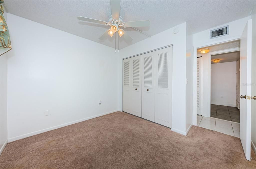 Primary bedroom w/view toward bathroom and walk-in closet