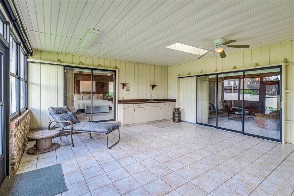 Enclosed porch under roof! 650 additional square feet with window AC unit!