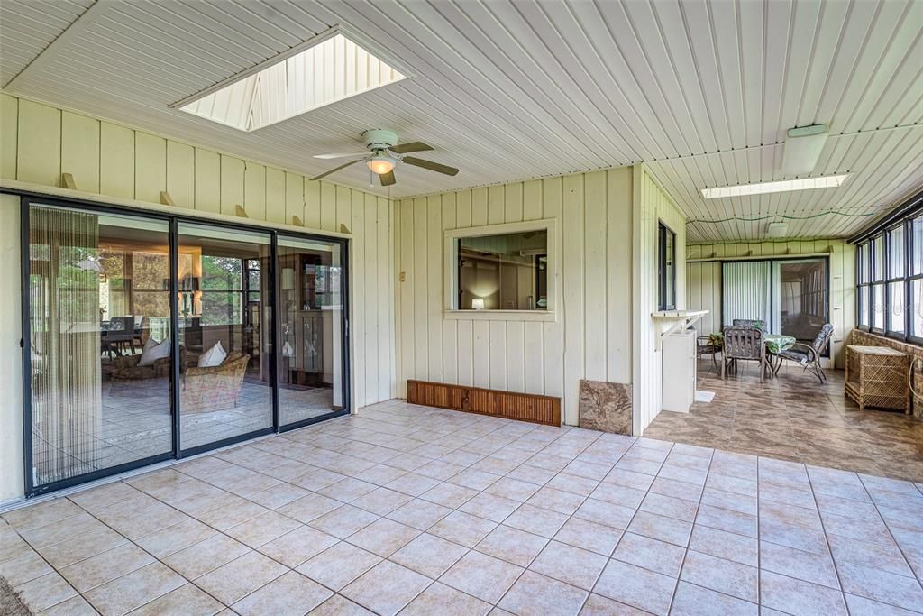 Enclosed porch under roof! 650 additional square feet with window AC unit!