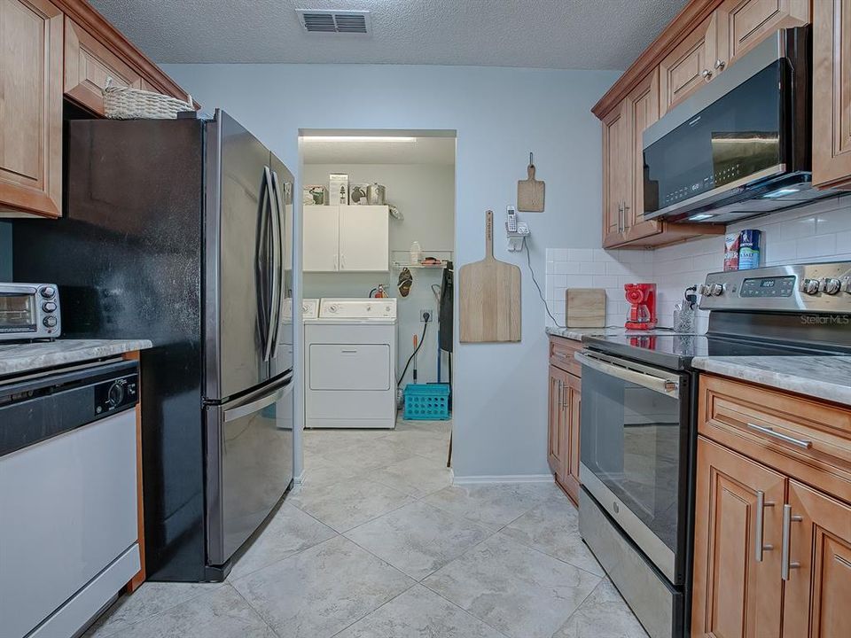 Inside washer and dryer with large pantry cabinet