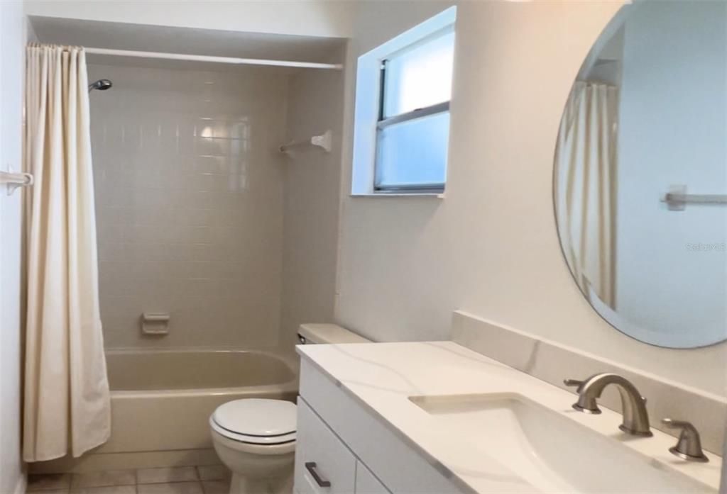 A beautiful full bath is located across the hallway from the secondary bedroom.