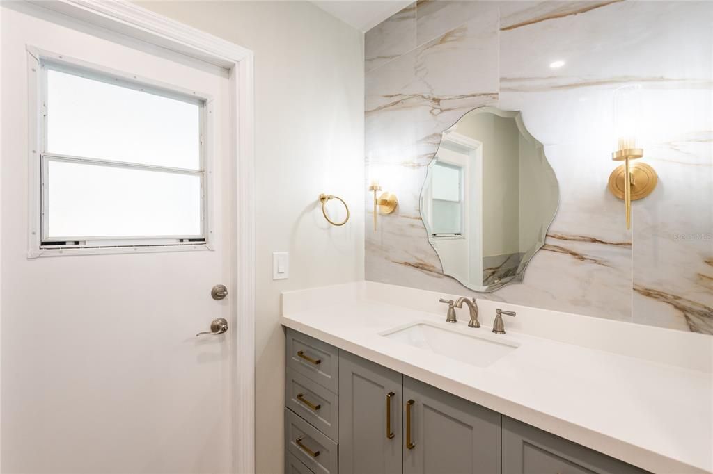 Luxurious 2nd bathroom with quartz counter tops and access to the pool.