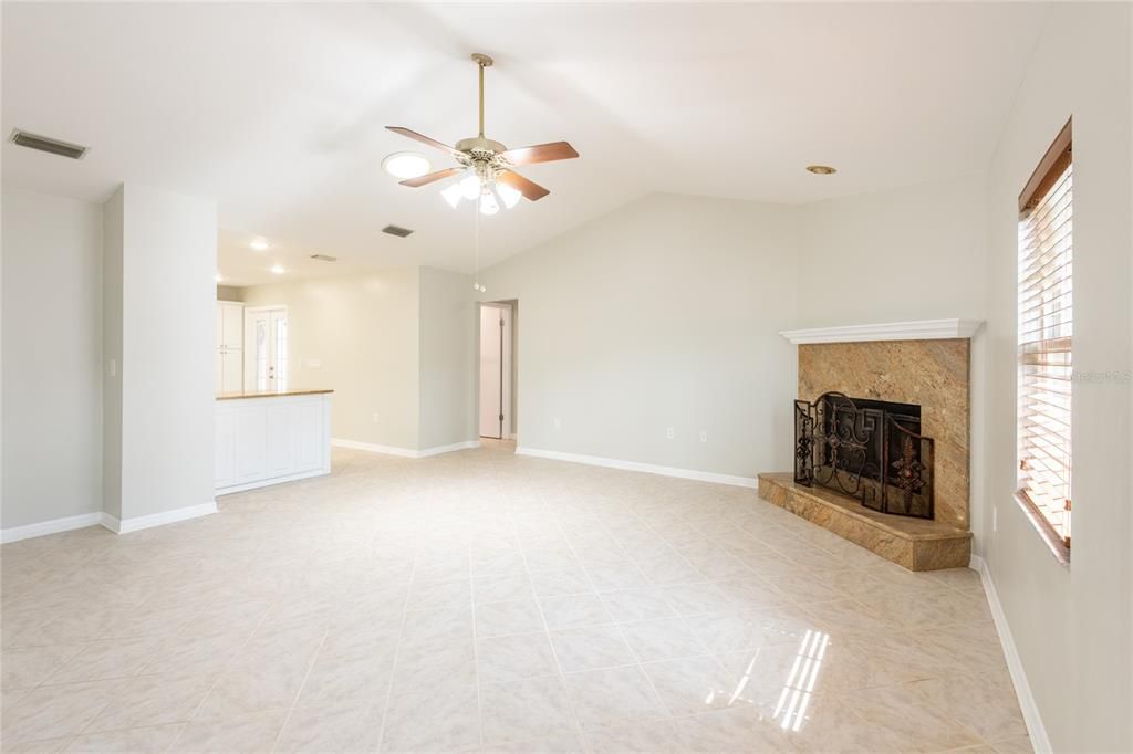 Large family room with wood burning fireplace.