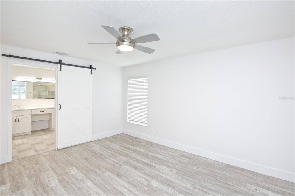 Primary Bedroom  - barn door to bathroom