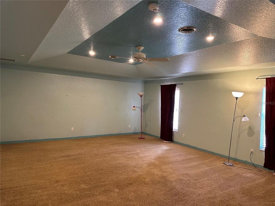 Huge master bedroom with recessed ceiling feature.