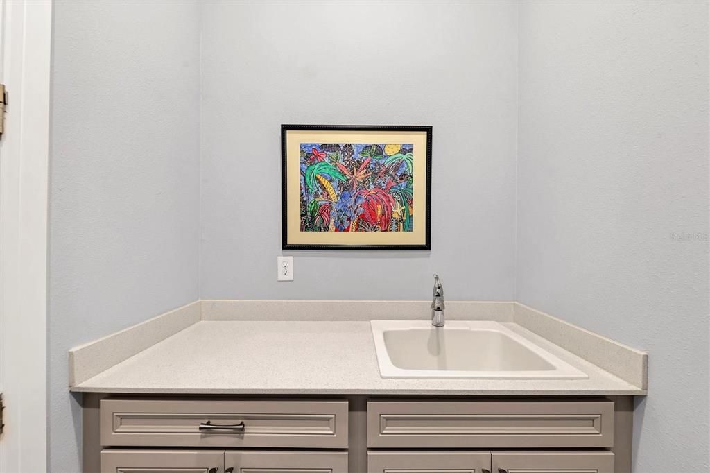 Laundry room with sink and cabinetry