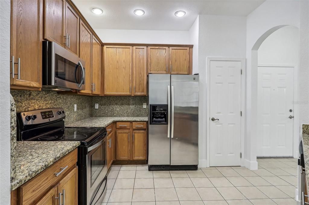 Kitchen features stainless appliances and granite countertops