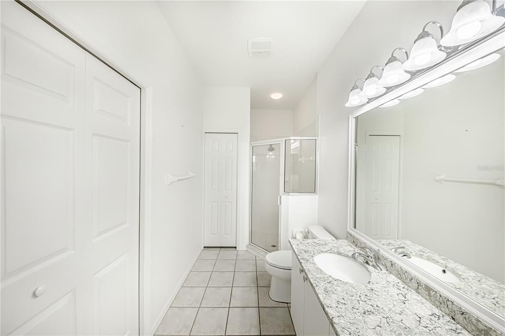 En-Suite Bath with walk-in closet to the left and ANOTHER CLOSET STRAIGHT AHEAD!