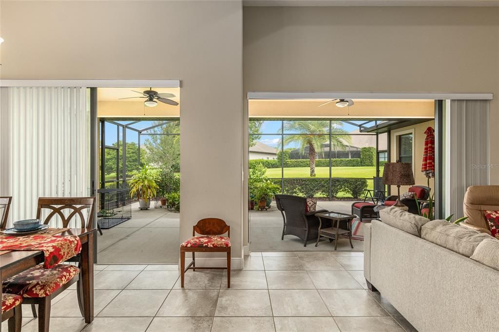 View through oversized patio, into yard from the kitchen, dining room and living room.