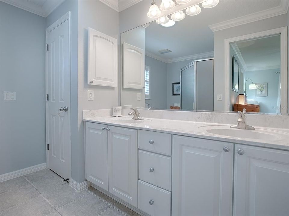 DUAL SINKS, LINEN CLOSET, CERAMIC TILE FLOORING AND WALK-IN SHOWER.