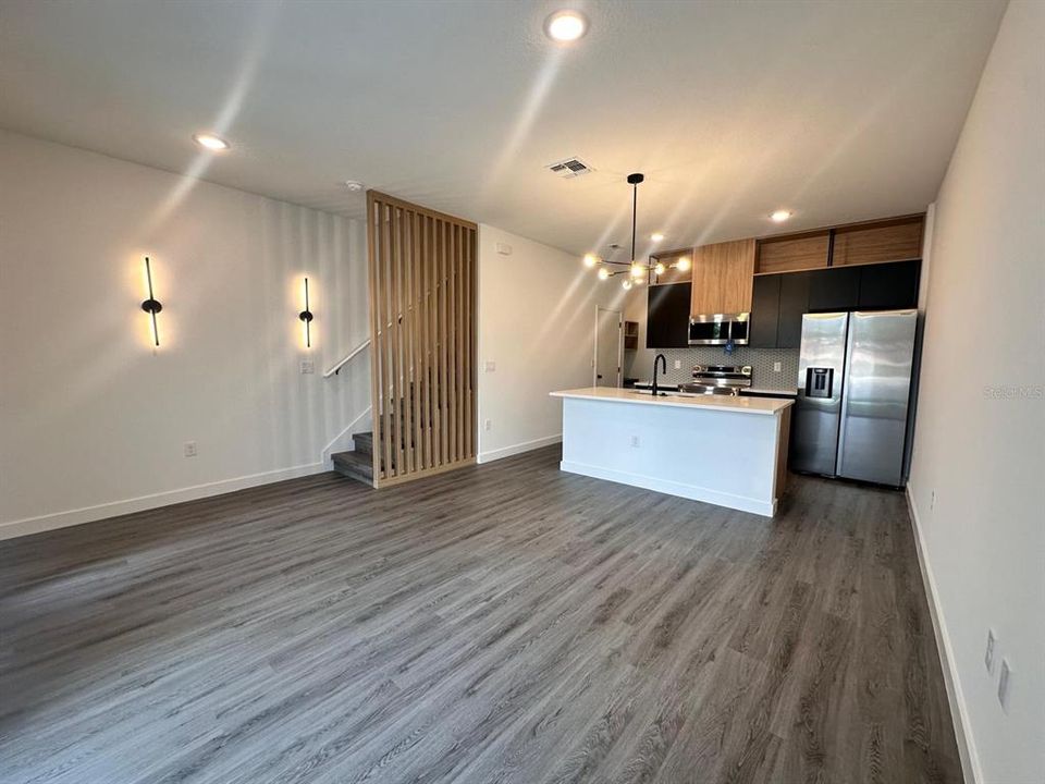 Upgraded cabinetry and lighting, quartz countertops, and wooden slats