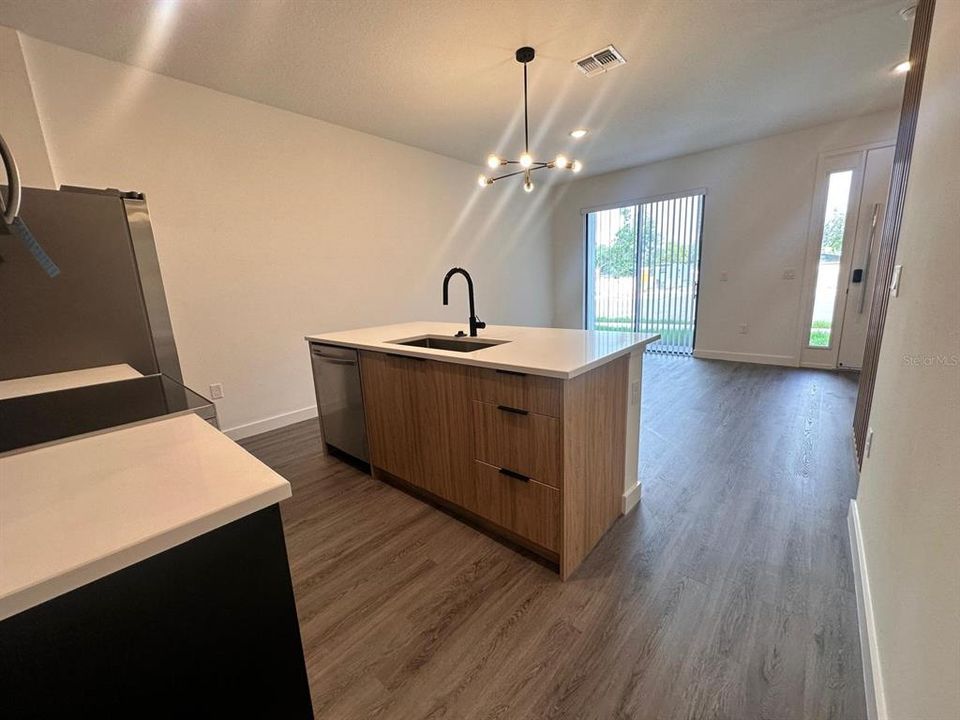 Upgraded cabinetry and lighting, quartz countertops, and wooden slats