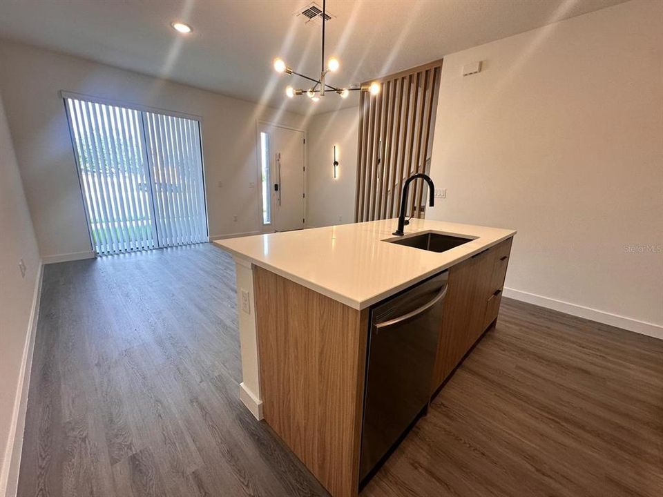 Upgraded cabinetry and lighting, quartz countertops, and wooden slats