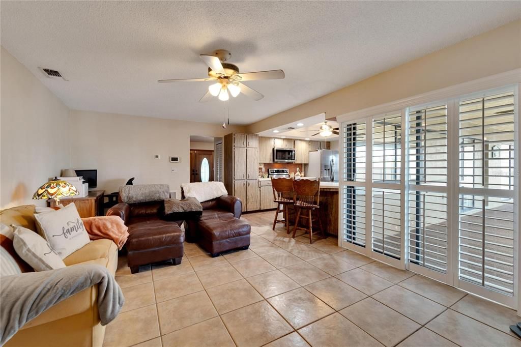 FAMILY ROOM WITH VIEW TO FOYER AND SLIDER TO LANAI